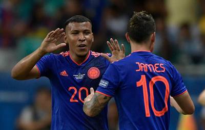 Colombia's Roger Martinez celebrates with teammate James Rodriguez. AFP