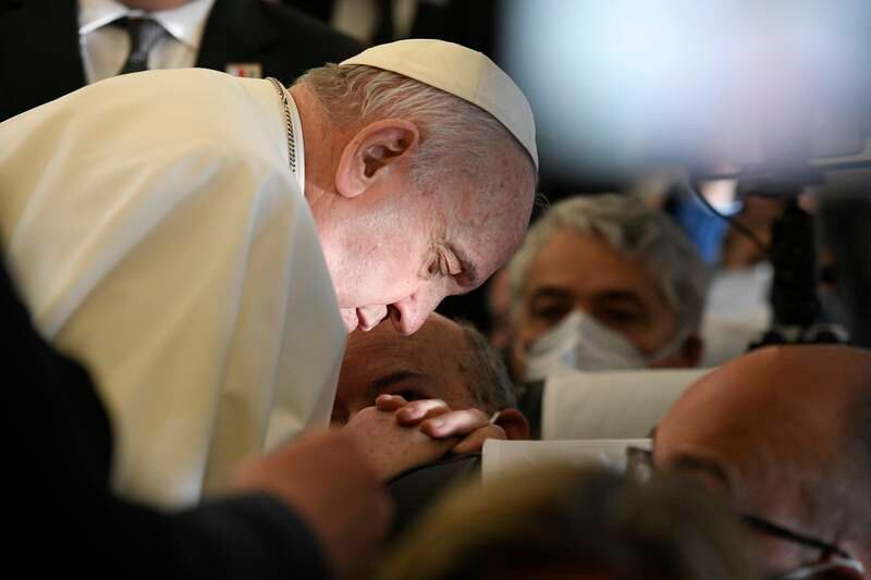 Pope Francis prays aboard the plane on his way to Malta International Airport. EPA