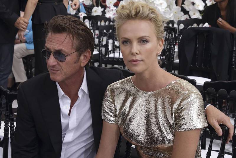 Sean Penn and Charlize Theron pose prior to Dior's Haute Couture Fall/Winter 2014-2015 fashion show. Philippe Wojazer / Reuters