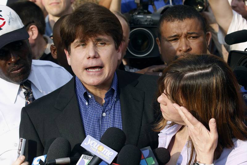 Former Illinois governor Rod Blagojevich speaks to the media outside his home in Chicago on March 14, 2012, as his wife, Patti, wipes away tears a day before reporting to prison after his conviction on corruption charges. AP