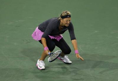 Victoria Azarenka of Belarus winces in pain after returning a shot to Lauren Davis during her loss at the BNP Paribas Open at Indian Wells. Jeff Gross / Getty Images / AFP / March 7, 2014   