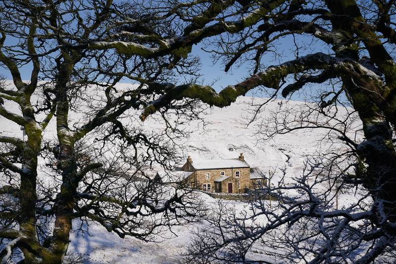 Tuesday recorded more snowfall in the north of the country, with this cottage near Carrshield in Northumberland blanketed overnight. PA