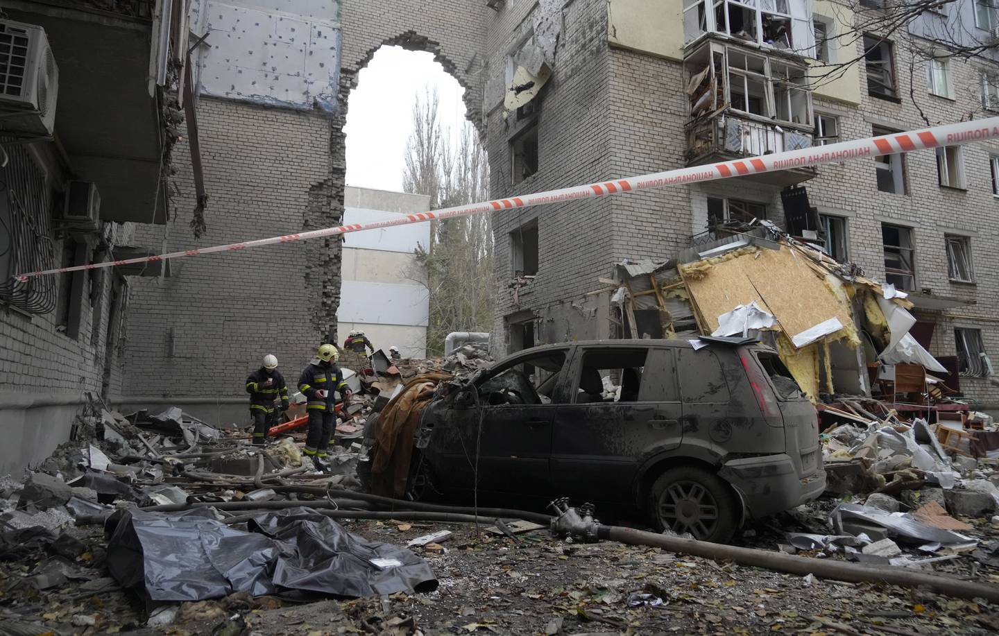 Ukrainian emergency service rescuers at the scene of a building damaged by shelling overnight in Mykolaiv. AP