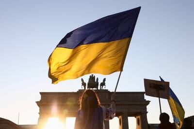 A person holds a Ukrainian flag during an anti-war demonstration at the Brandenburg Gate in Berlin, Germany. Reuters
