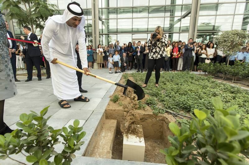 Dubai, United Arab Emirates, October 15, 2017:    Dr. Abdulla Al Karam, chairman of board of directors and director general of the Knowledge and Human Development Authority, KHDA, buries a time capsule of student work during the official opening of North London Collegiate School in the Nad Al Sheba area of Dubai on October 15, 2017. Christopher Pike / The National

Reporter: Nick Webster
Section: News