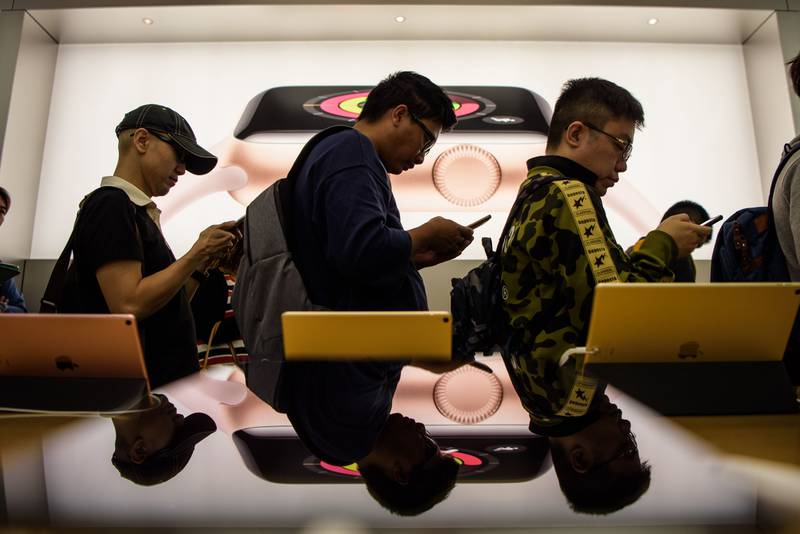 Customers queue at an Apple store to buy the 10th anniversary iPhone X in Hong Kong on November 3, 2017. Anthony Wallace / AFP