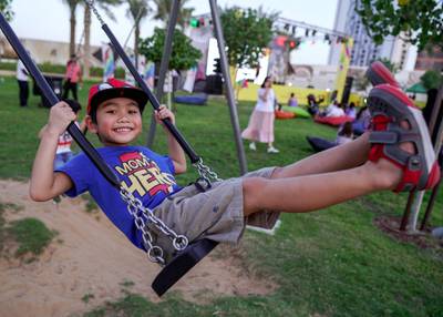 Abu Dhabi, United Arab Emirates, October 17, 2019.  Reem Festival.--Yumi Firdaus from Brunei enjoys the swing at the playground.Victor Besa/The NationalSection:  NAReporter:  Panna Munyal