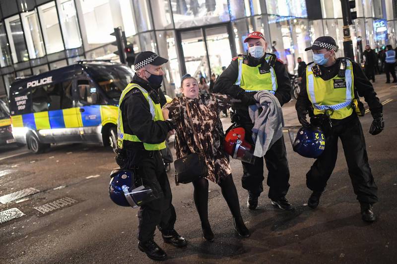 A woman is arrested by Police during a demo on Oxford Street on November 5, 2020 in London, England. Getty Images