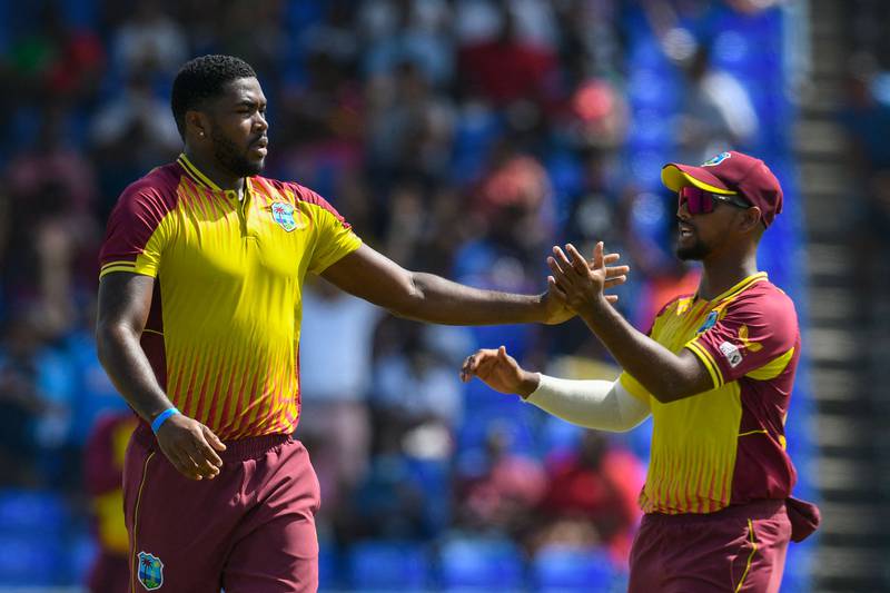 Obed McCoy, left, and West Indies captain Nicholas Pooran celebrate the dismissal of India's Ravindra Jadeja in the second T20 in Basseterre, St Kitts and Nevis. AFP