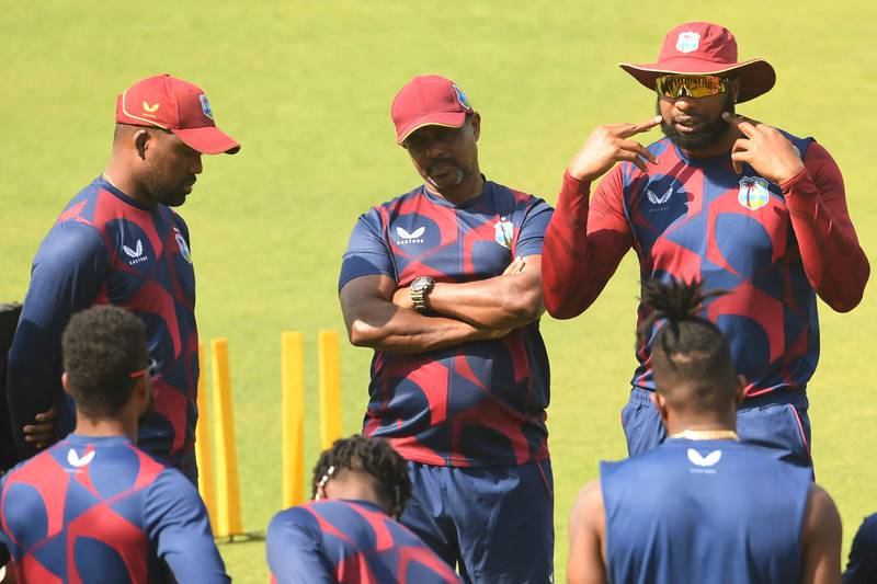 West Indies captain Kieron Pollard, right, with teammates during training. AFP