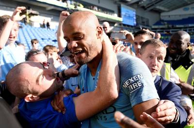 Manchester City's Vincent Kompany celebrates with fans after winning the Premier League title. Reuters