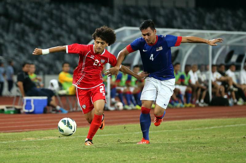 Omar Abdulrahman, left, is challenged by a Malaysian defender during the UAE's 3-1 win against Malaysia in a friendly played in Shenzhen, China, on Wednesday. Photo courtesy of the UAE FA
