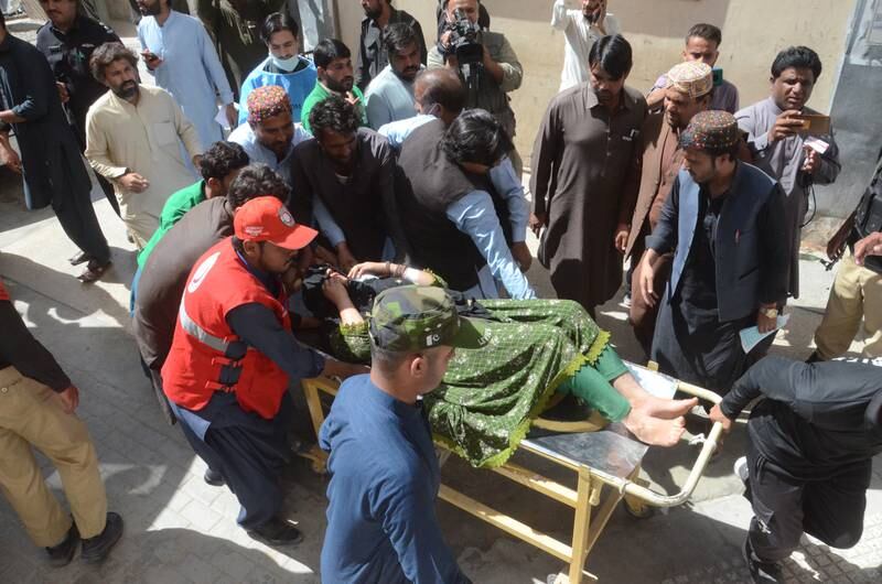 People carry one of the injured people to a hospital in Quetta after the 5.7-magnitute earthquake struck south-west Pakistan. EPA