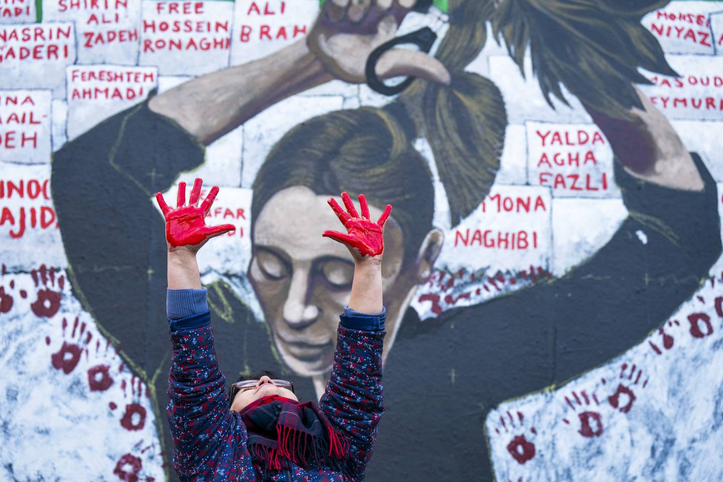 An Iranian woman helps to create the Women Life Freedom mural in Edinburgh, Members of the public are being invited to add their hand-print to the artwork to help raise awareness about the ongoing uprising in Iran. PA