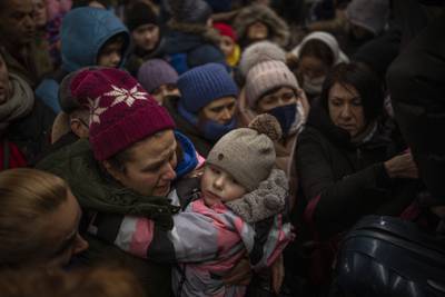 Women and children try to board a train bound for Lviv, at a station in Kyiv. AP