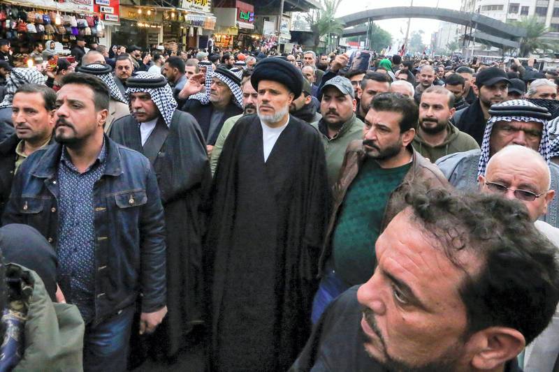 Mohammed al-Tabatabai (C), deputy Secretary General of the Asaib Ahl al-Haq faction, attends the funeral of Iraqi paramilitary chief Abu Mahdi al-Muhandis and Iranian military commander Qasem Soleimani, in Kadhimiya, a Shiite pilgrimage district of Baghdad, on January 4, 2020. - Thousands of Iraqis chanting "Death to America" joined the funeral procession for Iranian commander Qassem Soleimani and Iraqi paramilitary chief Abu Mahdi al-Muhandis, both killed in a US air strike. The cortege set off around Kadhimiya, a Shiite pilgrimage district of Baghdad, before heading to the Green Zone government and diplomatic district where a state funeral was to be held attended by top dignitaries. In all, 10 people -- five Iraqis and five Iranians -- were killed in Friday morning's US strike on their motorcade just outside Baghdad airport. (Photo by SABAH ARAR / AFP)