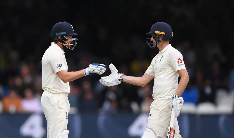 LONDON, ENGLAND - AUGUST 11:  England batsman Chris Woakes reaches his 50 and is congratulated by Jonny Bairstow (l) during Day 3 of the 2nd Test Match between England and India at Lord's Cricket Ground on August 11, 2018 in London, England.  (Photo by Stu Forster/Getty Images)