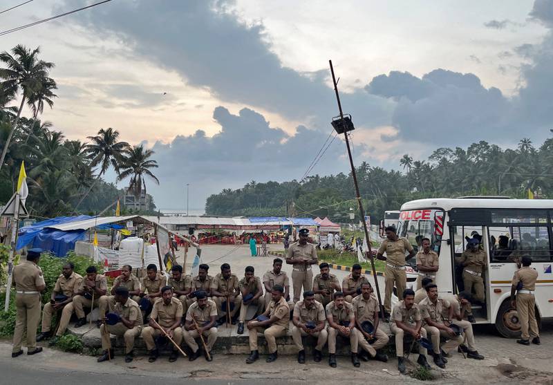 Policemen at the entrance of the proposed Vizhinjam Port in India's Kerala state, which, residents say, is destroying the local ecosystem. Reuters