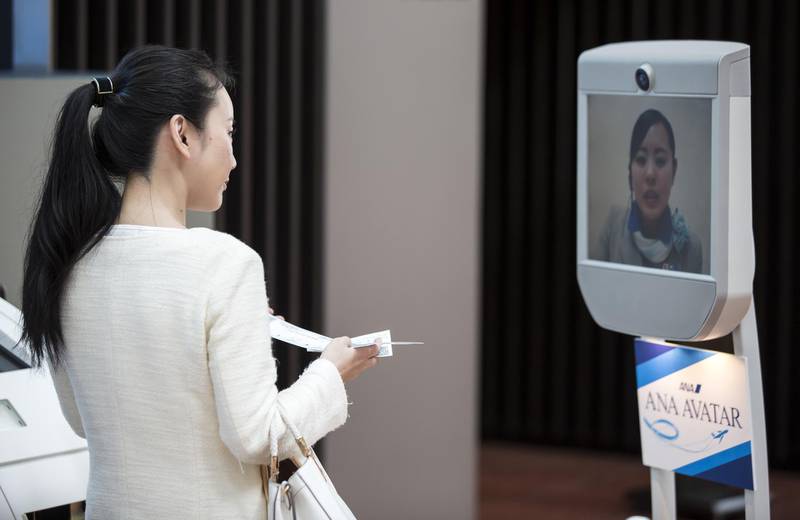 An ANA Holdings Inc. employee is seen on a Beam Pro telepresence robot manufactured by Suitable Technologies Inc. during a demonstration at a news conference on the ANA Avatar Vision project at Haneda Airport in Tokyo, Japan, on Thursday, March 29, 2018. ANA, Japan's largest airline carrier, unveiled the project that will "advance and pioneer real-world avatar technologies," according to the company. Photographer: Tomohiro Ohsumi/Bloomberg