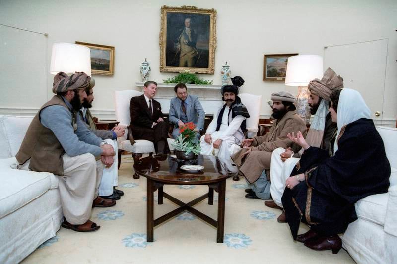President Ronald Reagan meets with Afghan Mujahideen representatives on February  2, 1983, in the Oval Office of the White House in Washington, to discuss Soviet atrocities in Afghanistan.  (Courtesy Ronald Reagan Library via AP)