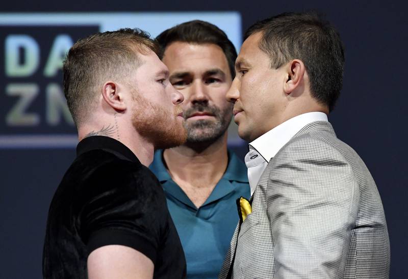 Canelo Alvarez and Gennady Golovkin face-off as promoter Eddie Hearn looks on. AFP
