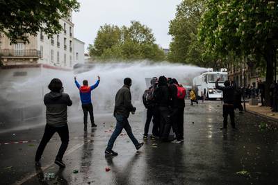 Police forces use a water cannon to disperse protesters on the Place de la Nation during May Day march on Saturday in Paris. AP Photo