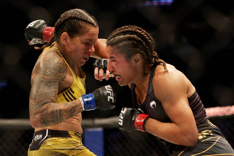 Julianna Pena punches Amanda Nunes during their bantamweight title bout at UFC 277. AFP
