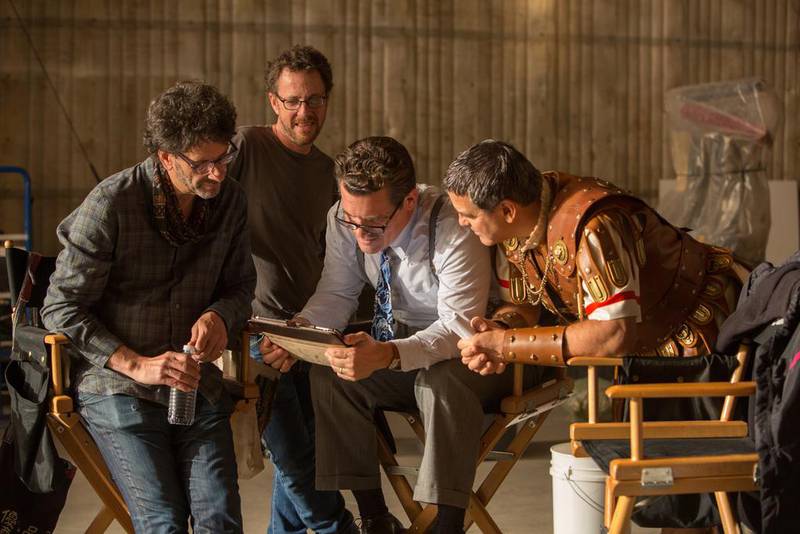 From left, filmmakers Joel and Ethan Coen are joined by Josh Brolin as Eddie Mannix and George Clooney as Baird Whitlock on the set of Hail​, Caesar!. Alison Rosa / Universal Pictures