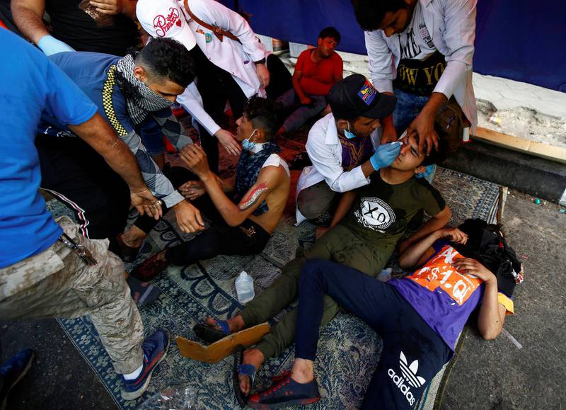 Iraqi demonstrators receives medical help during ongoing anti-government protests in Baghdad, Iraq. Reuters