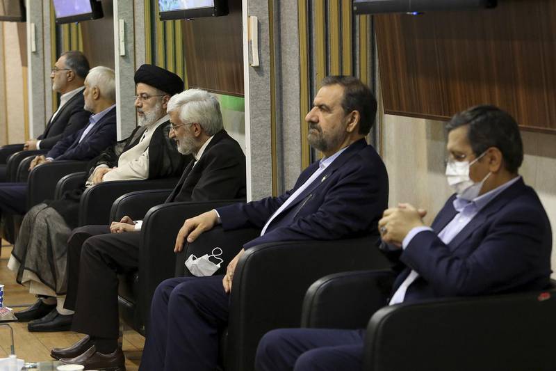 Presidential candidates for Iran's election June 18, from right to left, Abdolnasser Hemmati, Mohsen Rezaei, Saeed Jalili, Ebrahim Raisi, Mohsen Mehralizadeh, and Alireza Zakani before their second debate on state-run TV, in Tehran. A seventh candidate, Amirhossein Ghazizadeh Hashemi, also attended the debate. AP