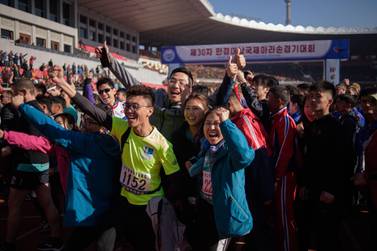 Foreign competitors cheer as they pose for photos at the starting line of the annual Mangyongdae Prize International Marathon, at the Kim Il Sung stadium in Pyongyang. AFP