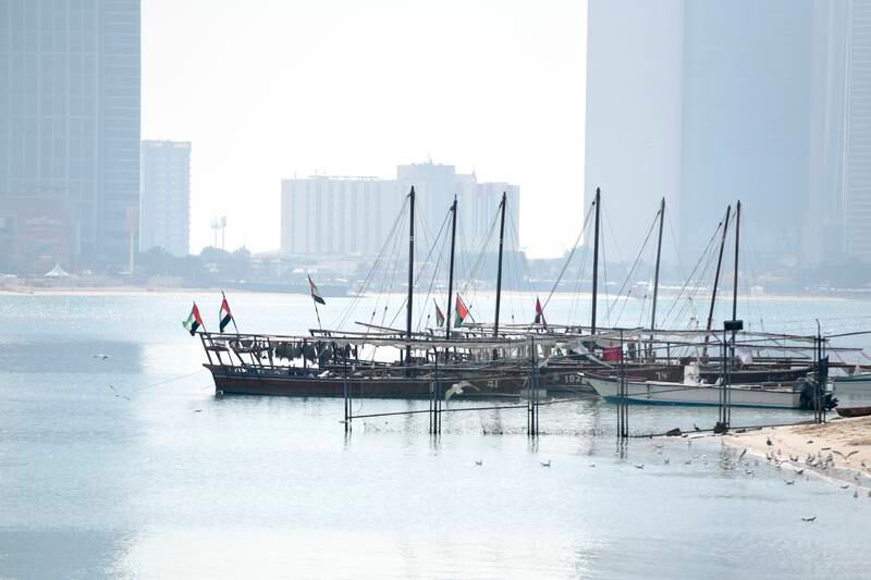 Dhows moored at the Heritage Village in Abu Dhabi. Khushnum Bhandari / The National
