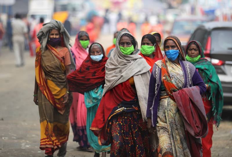 Indian devotees walk for a health check-up at the Babughat transit camp before the Ganga Sagar annual fair in Kolkata, eastern India. EPA
