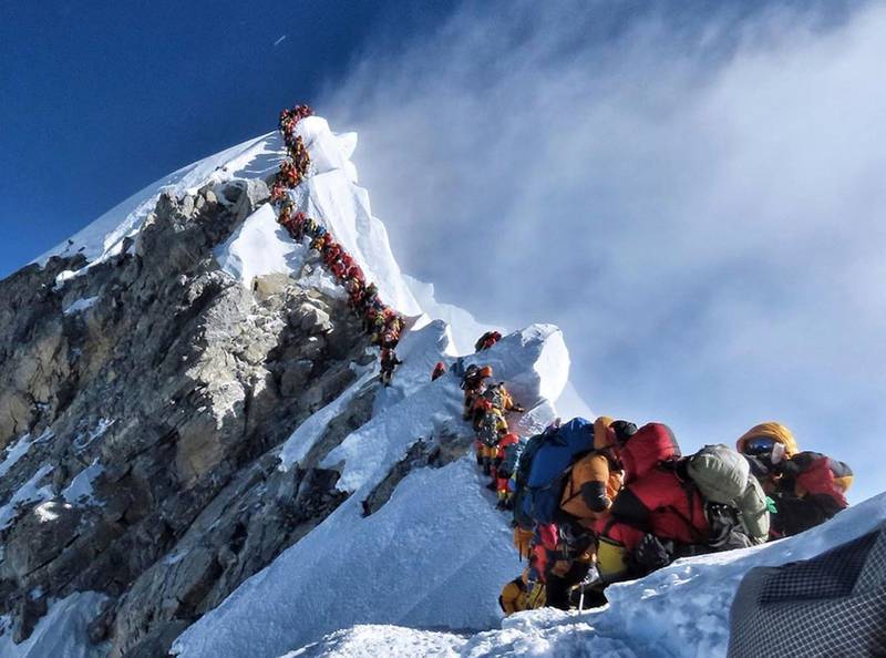 In this photo made on May 22, 2019, a long queue of mountain climbers line a path on Mount Everest. About half a dozen climbers died on Everest last week most while descending from the congested summit during only a few windows of good weather each May. (Nirmal Purja/@Nimsdai Project Possible via AP)