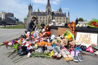 Canadian Prime Minister Justin Trudeau visits the makeshift memorial erected in honour of the 215 indigenous children in Ottawa. AFP