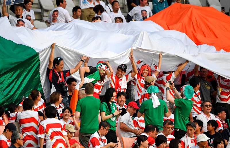 A giant Irish flag makes it's way through the crowd during the Japan 2019 Rugby World Cup Pool A match between Japan and Ireland at the Shizuoka Stadium Ecopa in Shizuoka. AFP