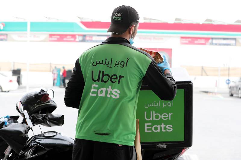 DUBAI, UNITED ARAB EMIRATES , April 11 – 2020 :- One of the Uber Eats delivery guy collecting order from ENOC gas station in Dubai. Dubai is conducting 24 hours sterilisation programme across all areas and communities in the Emirate and told residents to stay at home. UAE government told residents to wear face mask and gloves all the times outside the home whether they are showing symptoms of Covid-19 or not. (Pawan Singh/The National) For News/Online/Instagram/Standalone