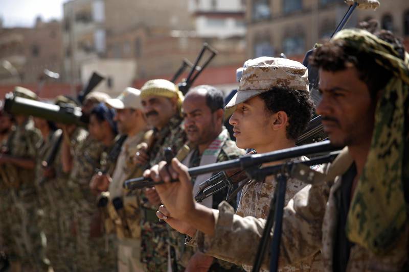 FILE - In this Feb. 20, 2020 file photo, Houthi rebel fighters display their weapons during a gathering aimed at mobilizing more fighters for the Iranian-backed Houthi movement, in Sanaa, Yemen.  (AP Photo/Hani Mohammed, File)