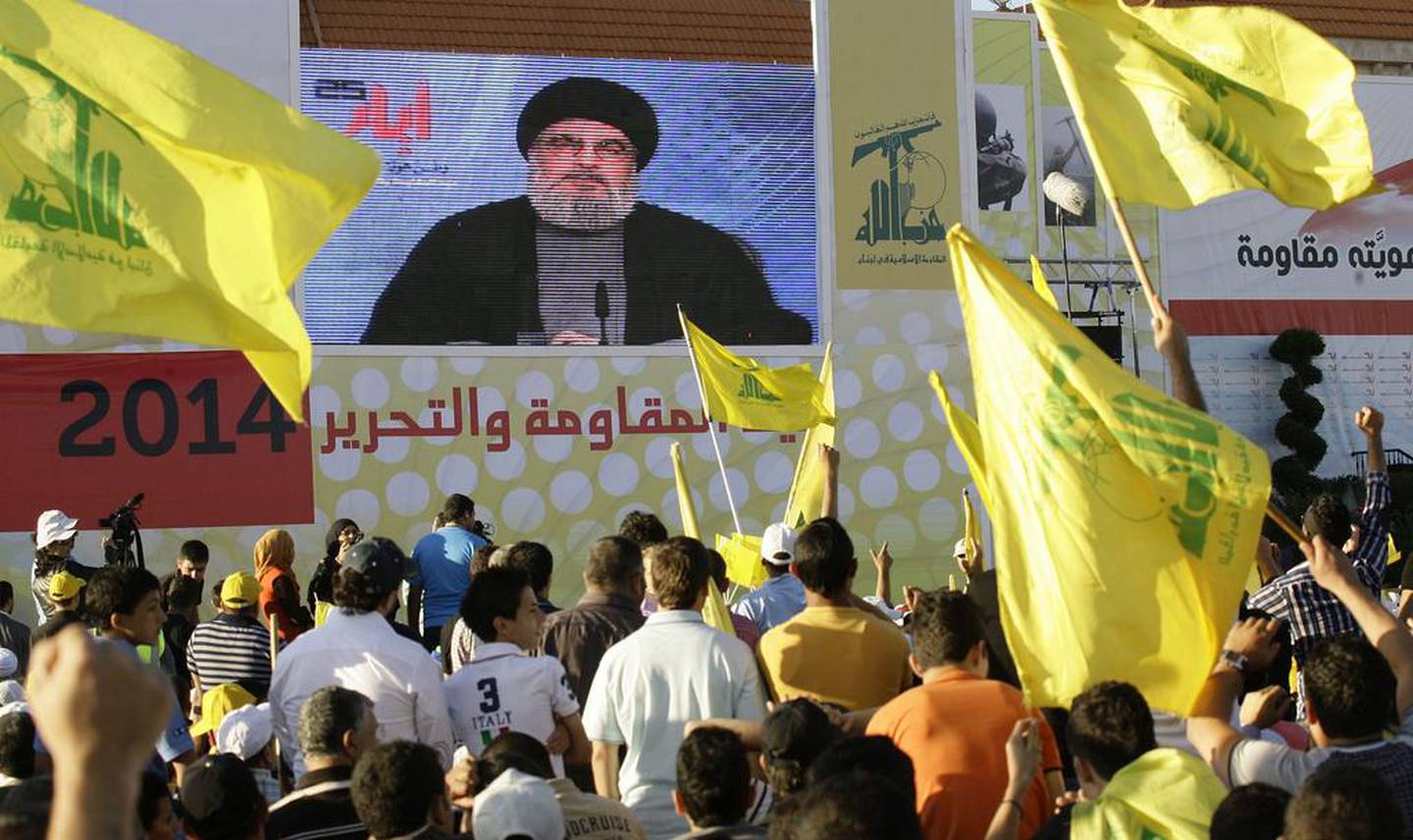 People listen to Hezbollah head Hassan Nasrallah as he speaks via a giant screen during the celebration in the southern town of Bint Jbeil, Lebanon. EPA