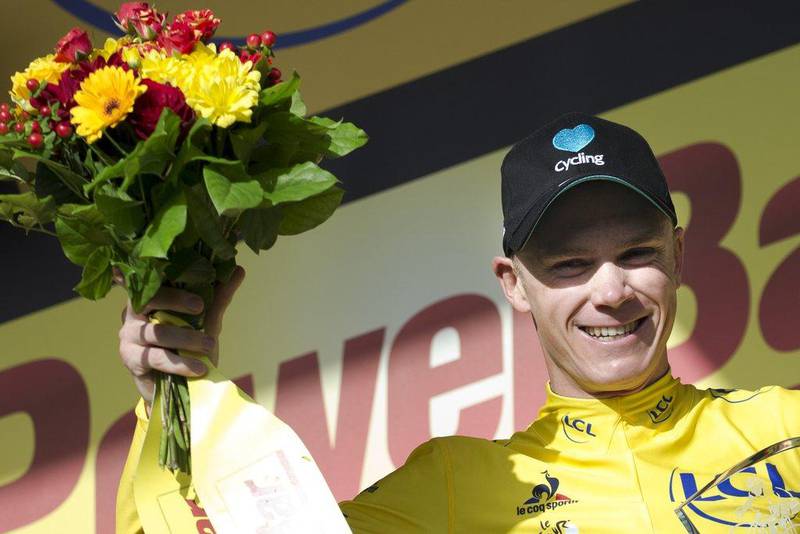 Britain's Chris Froome, wearing the overall leader's yellow jersey, celebrates on the podium after Stage 18 of the Tour de France. Peter Dejong / AP Photo