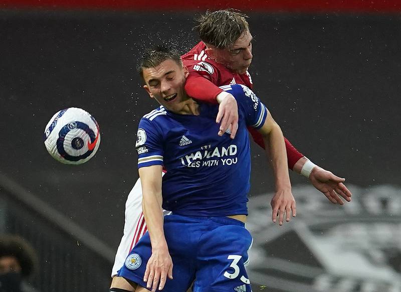 Leicester's Luke Thomas and Brandon Williams of United challenge for a header. Reuters