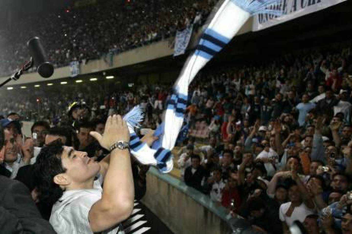 Former Argentine soccer star Diego Armando Maradona blows kisses to his fans in the San Paolo stadium in Naples, southern Italy, Thursday, June 9, 2005. Maradona returned to Naples after a 14-year absence to attend former Napoli teammate Ciro Ferrara's farewell match at San Paolo stadium.(AP Photo/Salvatore Laporta)