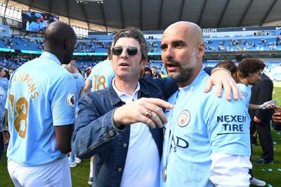 MANCHESTER, ENGLAND - MAY 06:  Noel Gallagher speaks to Josep Guardiola, Manager of Manchester City on the pitch after the Premier League match between Manchester City and Huddersfield Town at Etihad Stadium on May 6, 2018 in Manchester, England.  (Photo by Michael Regan/Getty Images)