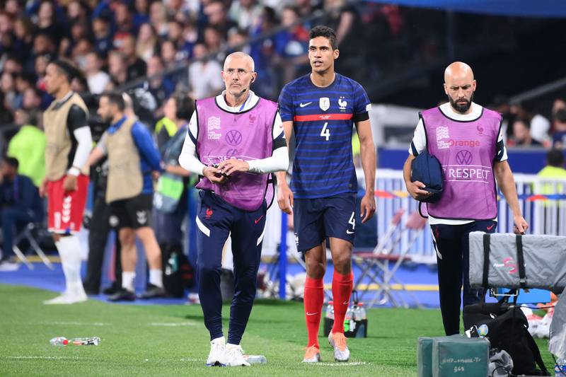 France's defender Raphael Varane walks off after picking up an injury. AFP