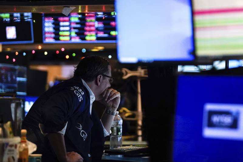 A trader works at the New York Stock Exchange. Investors playing catch-up to a rally that added 14 per cent from October’s lows piled back in last week hoping to ride a year-end surge. AP