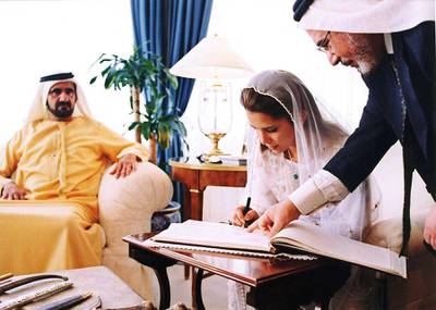 Jordan's Princess Haya, King Abdullah II's half-sister, right, signs her wedding register to Dubai's Crown Prince and Defence Minister Mohammed bin Rashed al-Maktoum, who is seen sitting at left, at the Baraka Palace in Amman, Jordan, Saturday April 10, 2004. Princess Haya, 29, is the eldest daughter of Jordan's late King Hussein from his third wife, Alia-Touqan, a Palestinian Jordanian who died in a 1977 helicopter crash. Prince Sheik Mohammed and Princess Haya,  were married Saturday.(AP Photo/Royal Palace)