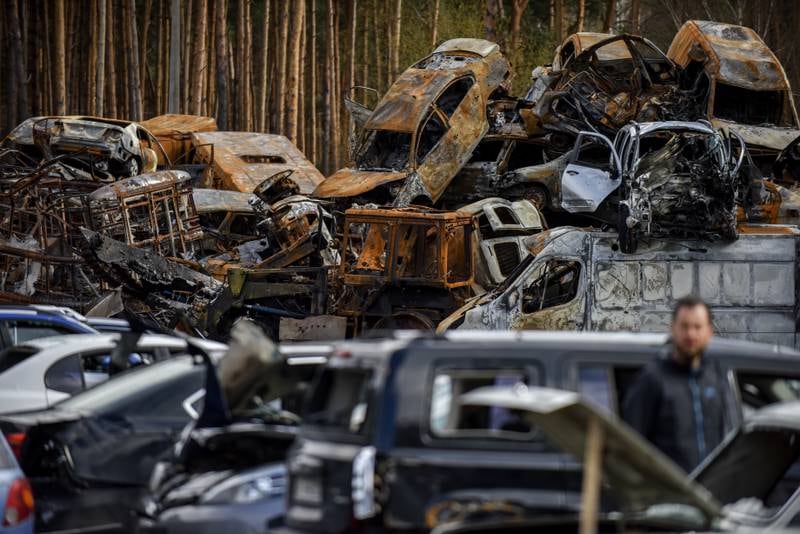 Vehicles destroyed during the Russian invasion lie at a junkyard in Irpin. EPA