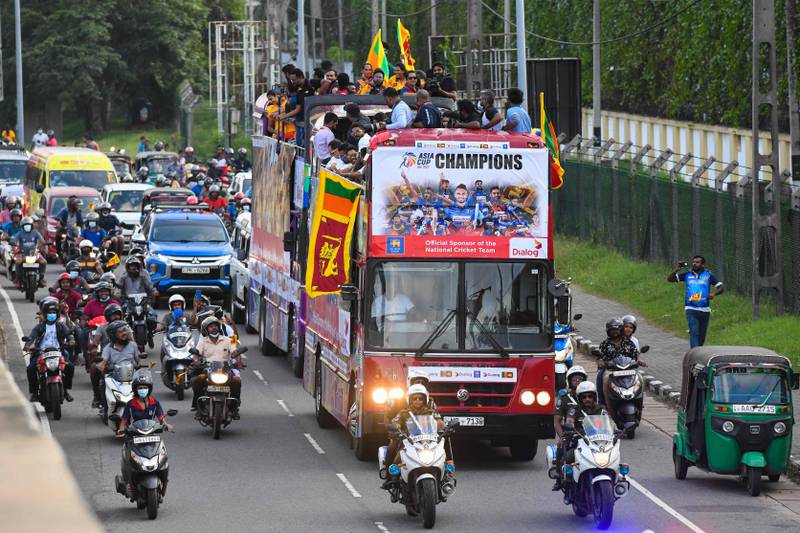 Members of the Sri Lankan team travel on an open-top bus in Colombo on Tuesday, September 13, 2022, to celebrate their victory in the Asia Cup T20 tournament in UAE. AFP