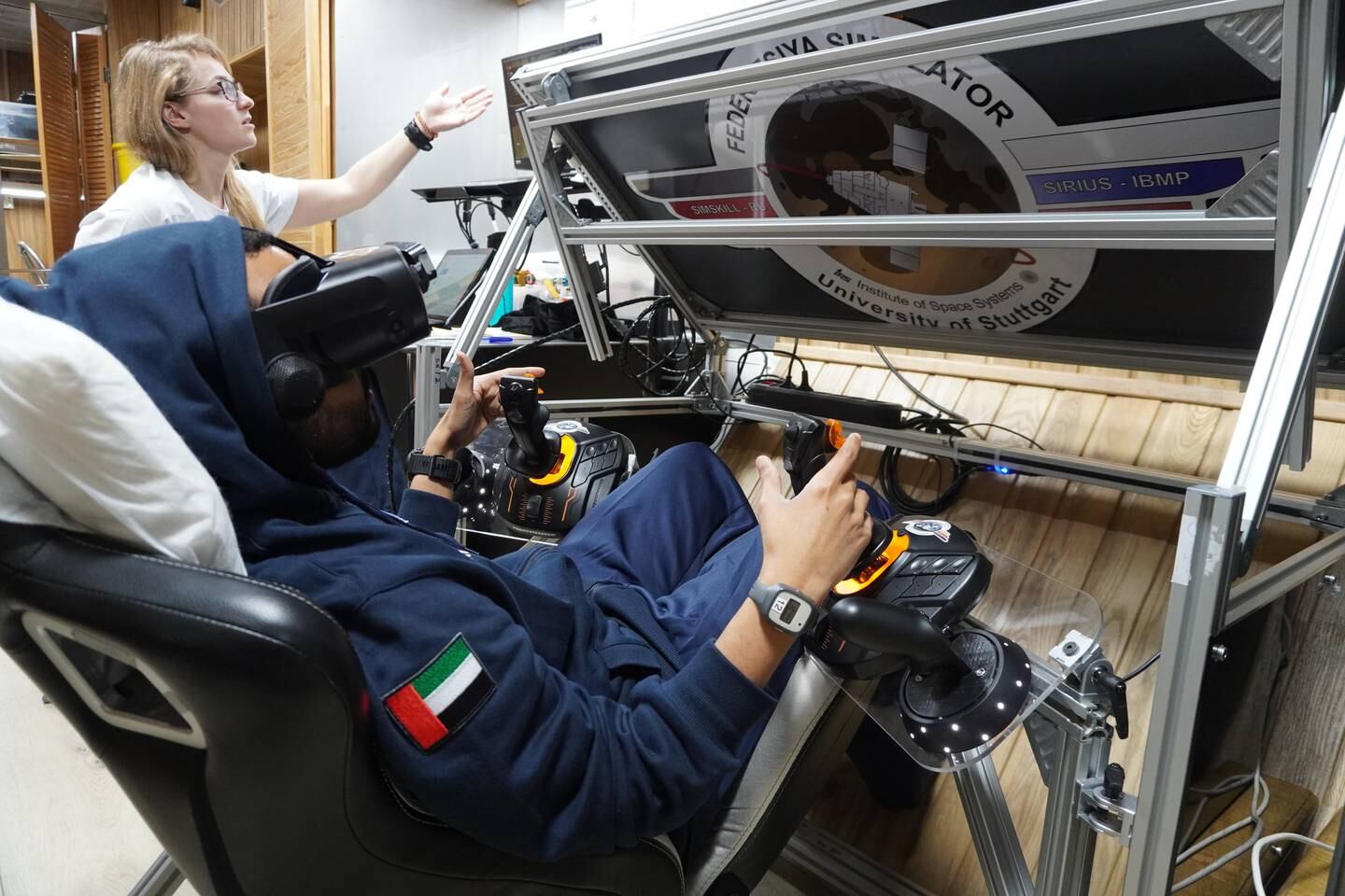 Saleh Al Ameri uses a virtual reality headset to 'fly a spaceship to the Moon'. Photo: MBRSC