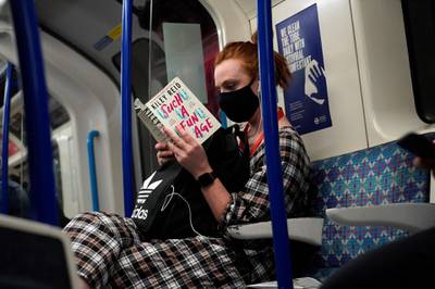 A commuter travels on a Transport for London Underground train in central London. AFP